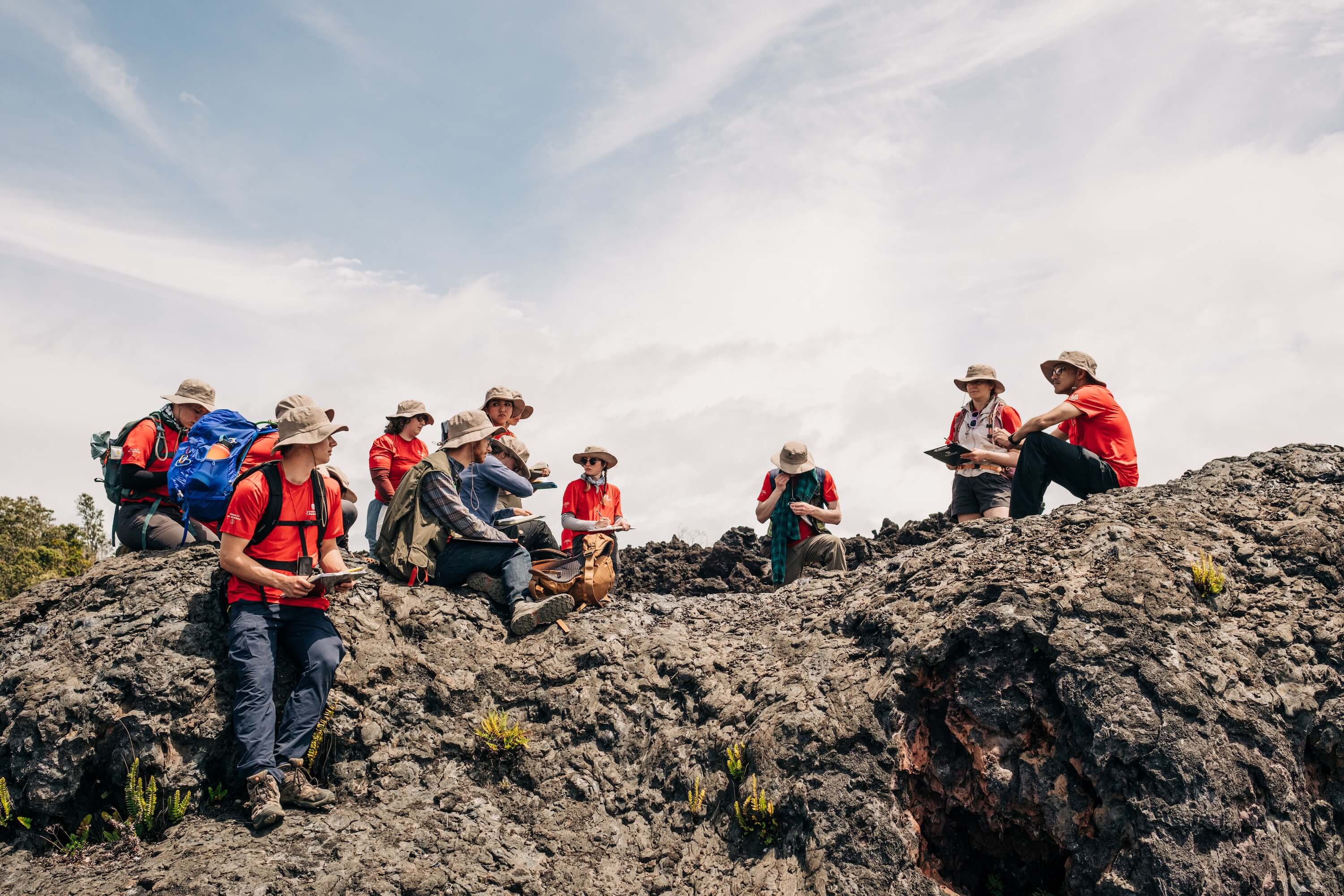 A group of students visit a volcano