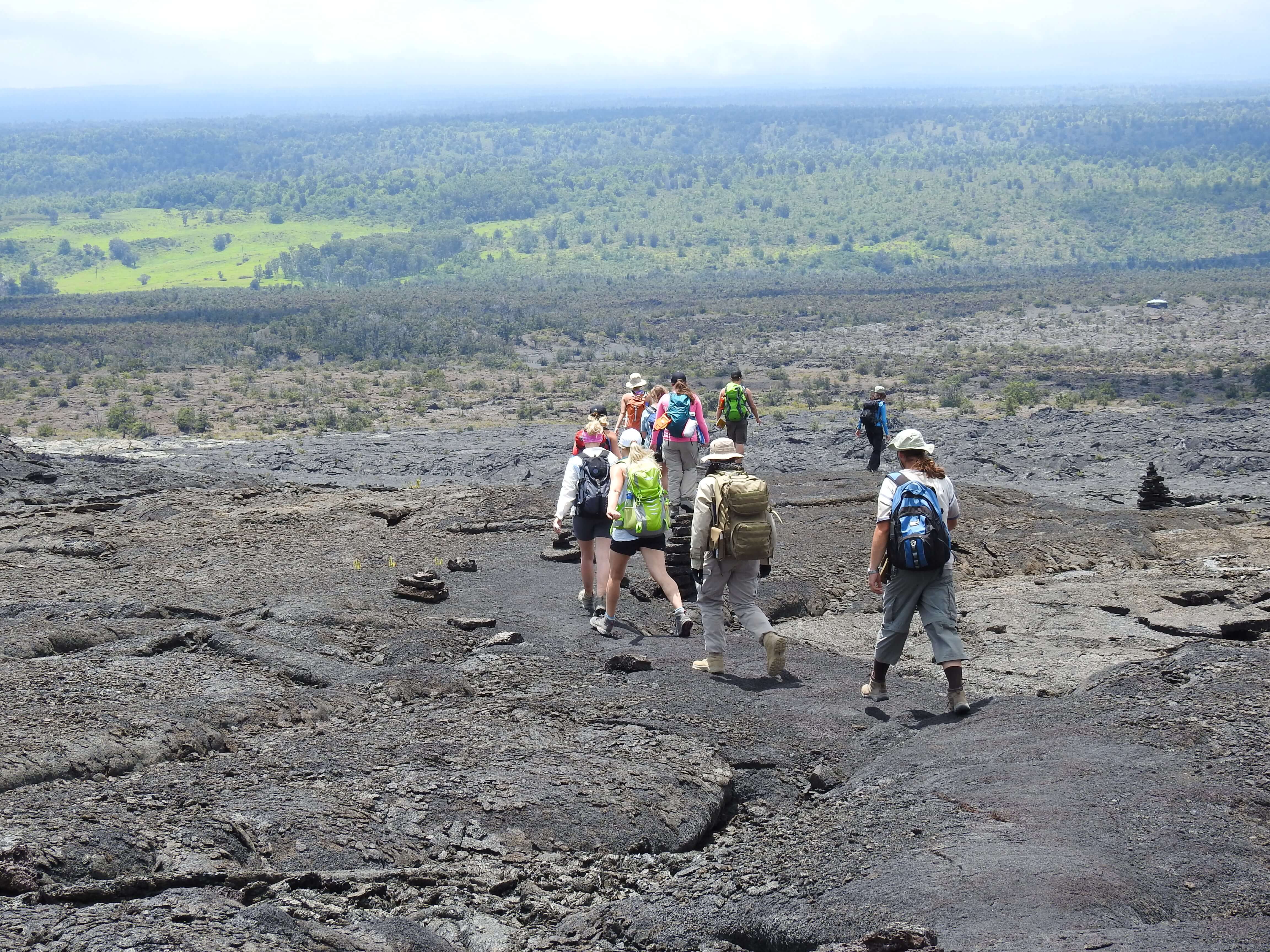 Students exploring a lava field