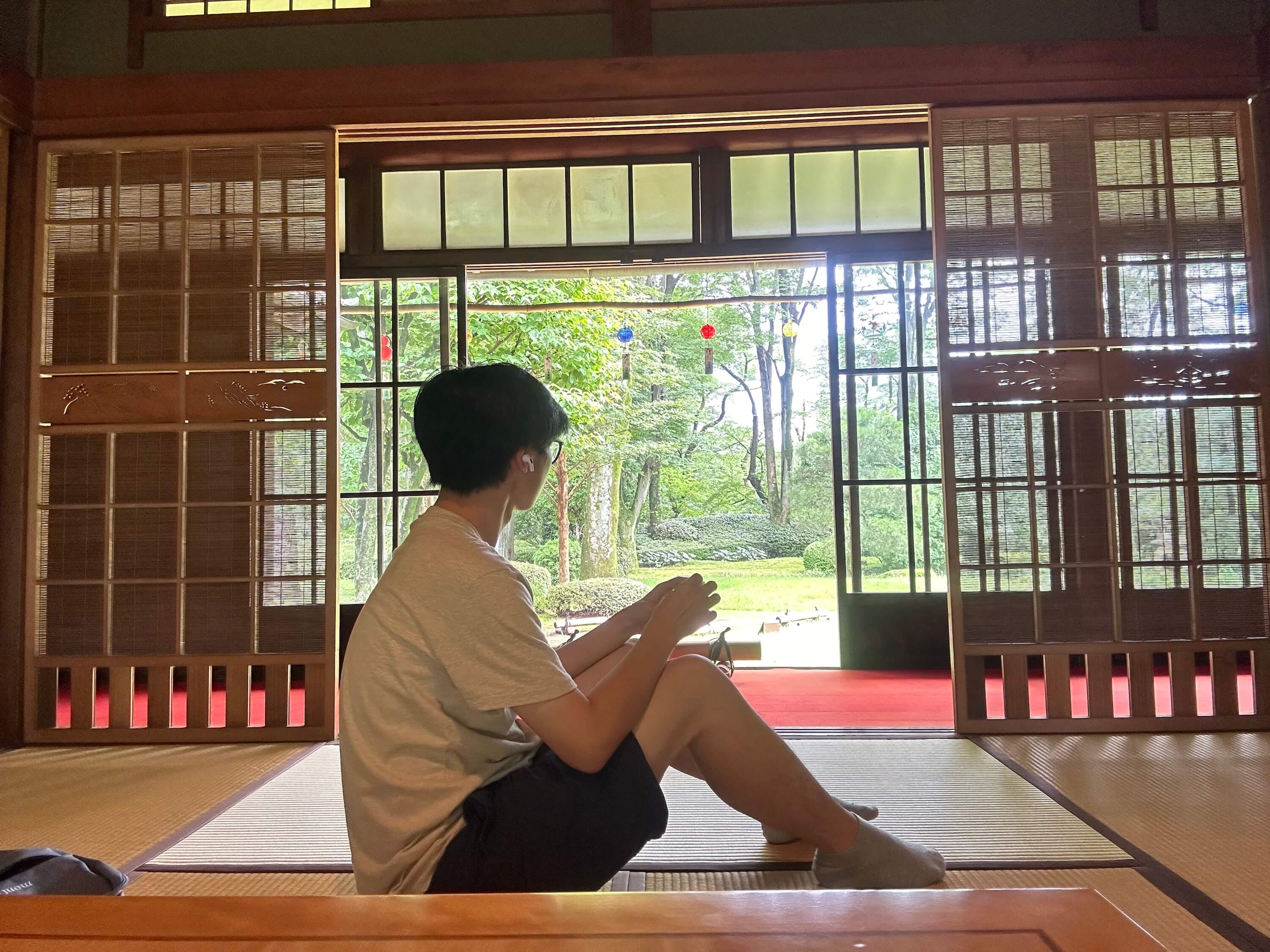 A student sitting in a building near a door